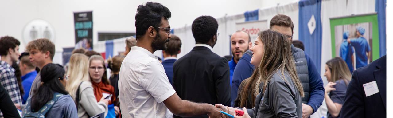 people shaking hands at the career fair